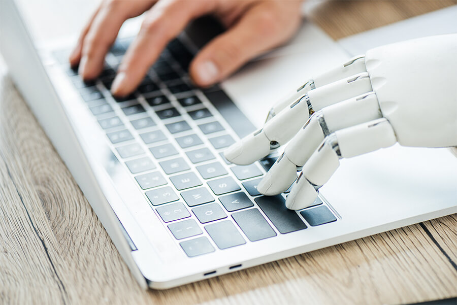 close-up-view-of-human-and-robot-hands-typing-on-l-2021-08-29-21-23-10-utc 2